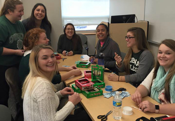 Students meet to work on their projects before the event.