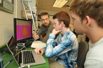 John Moustakas, Ph.D. (left), working on Hubble related data with Siena physics majors Jack Rogers ’15 and Joey Rowley ’16 last summer.