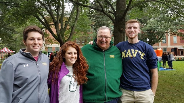 Kiera posed with friends and Fr. Kevin Mullen at Siena