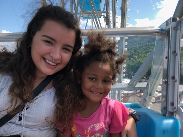 Lilly poses with a student in their program