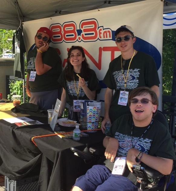 Carli poses with the Siena Radio Station banner